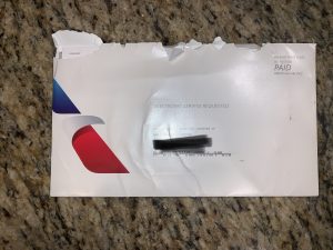 a white envelope with a black and red logo on it