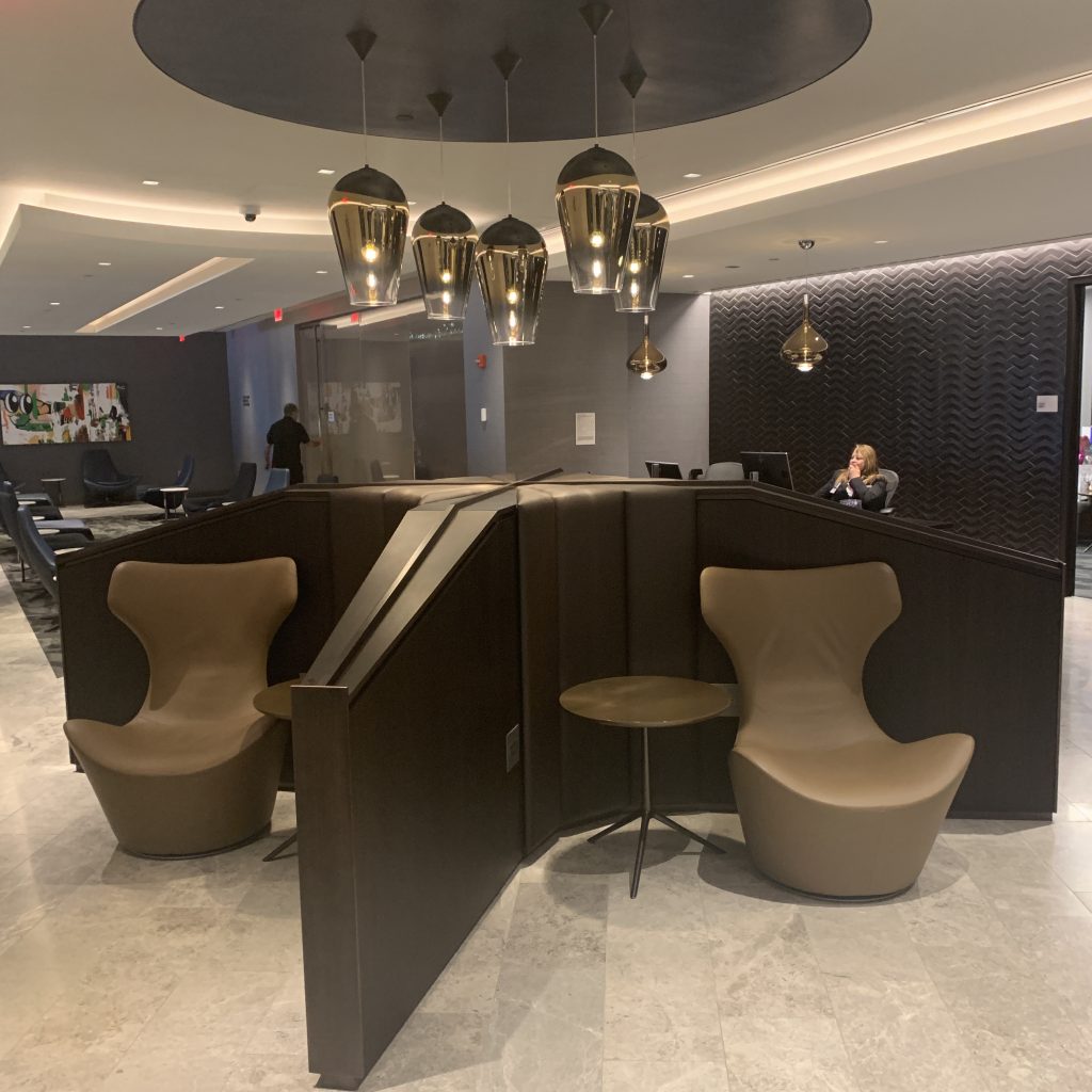a lobby with a desk and chairs