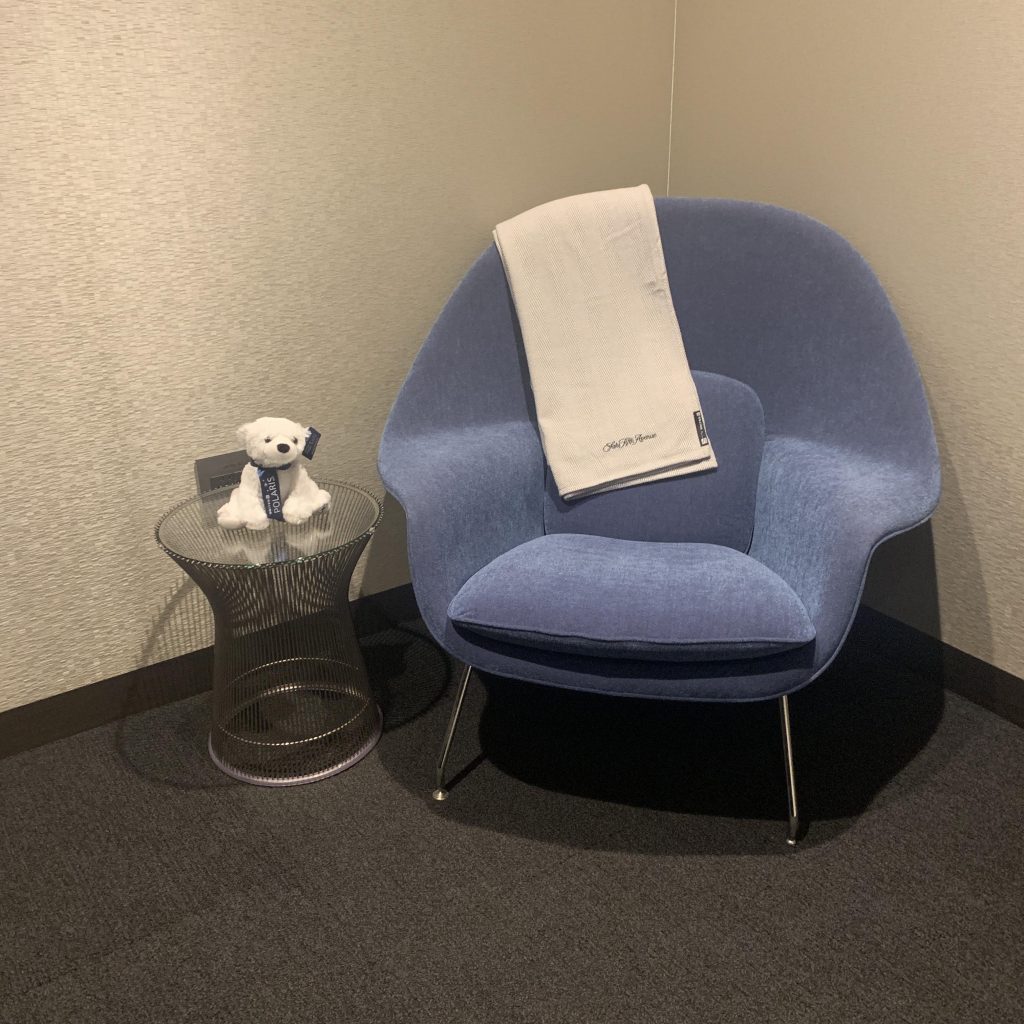 a blue chair with a white towel on it