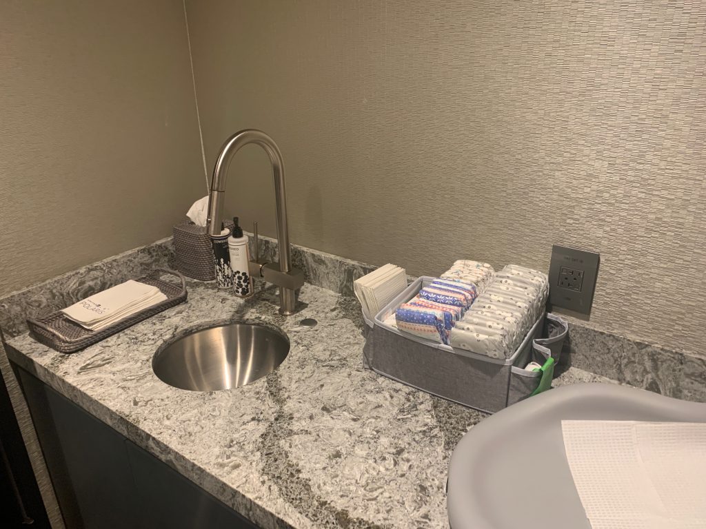 a sink and a tray of tissues