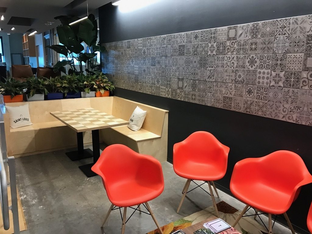a room with orange chairs and a table