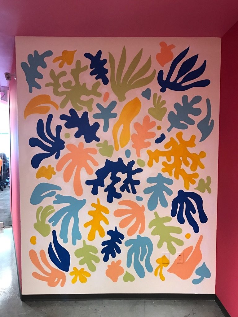 a wall with colorful leaves on it