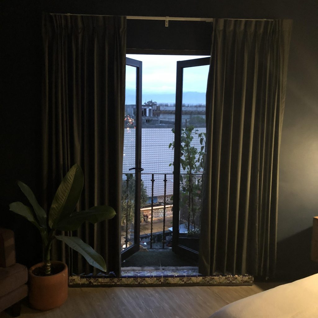 a room with a door open and a plant