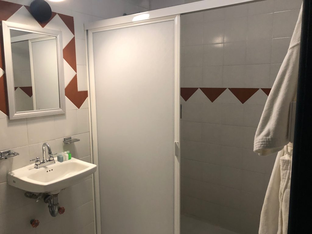 a bathroom with a white towel on a door