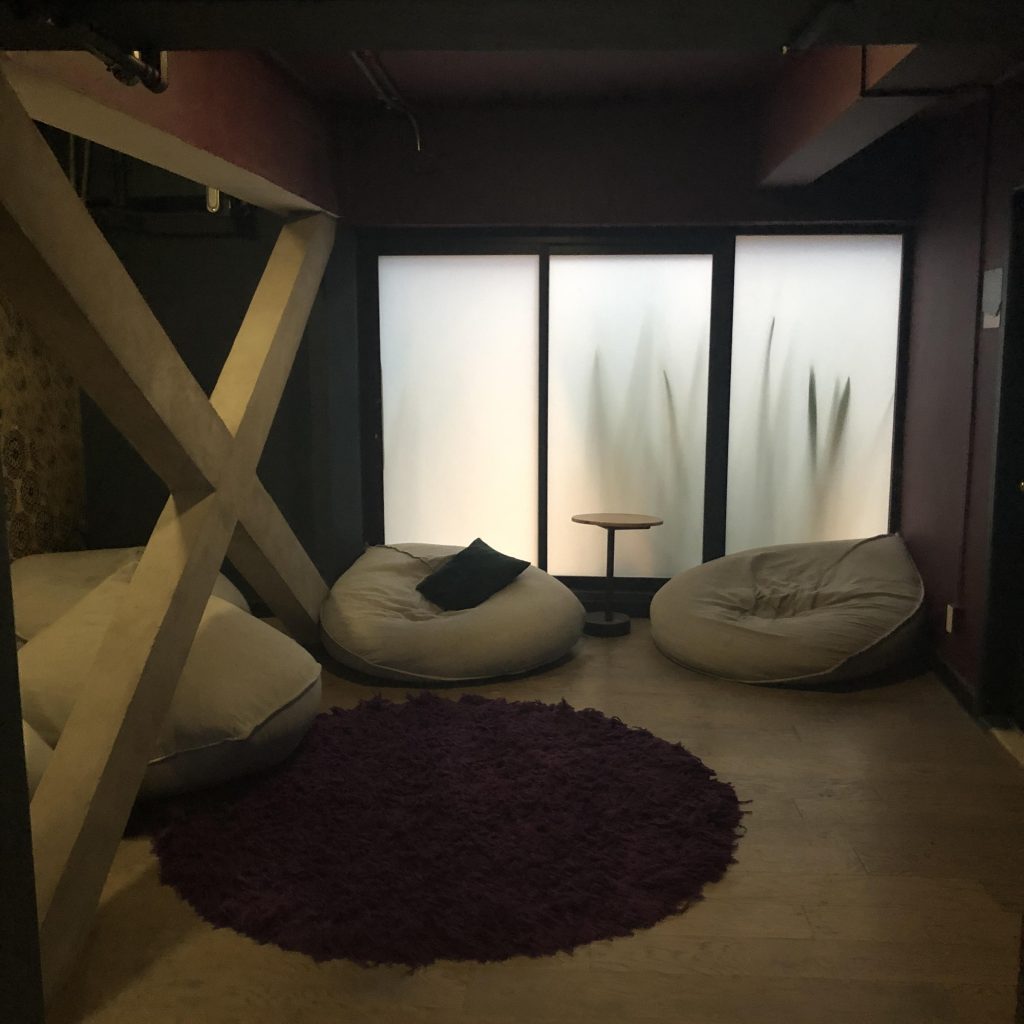 a room with bean bags and a purple rug